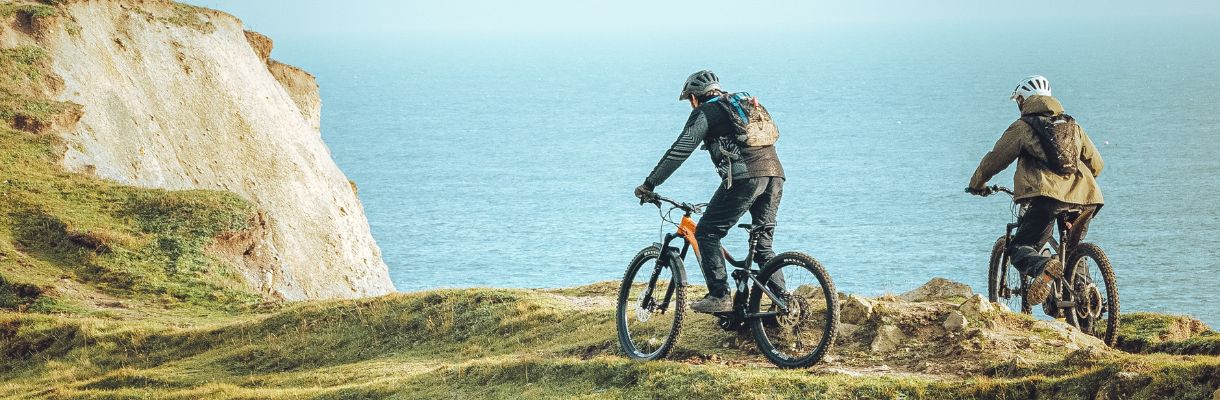 Couple cycling along the coast on the Isle of Wight